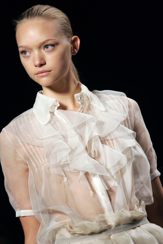 Model in sheer ruffled blouse