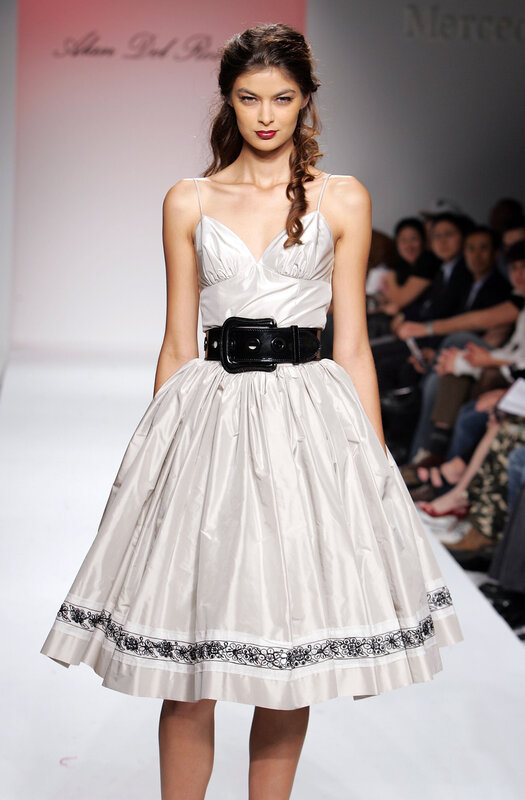 Model in white dress on runway