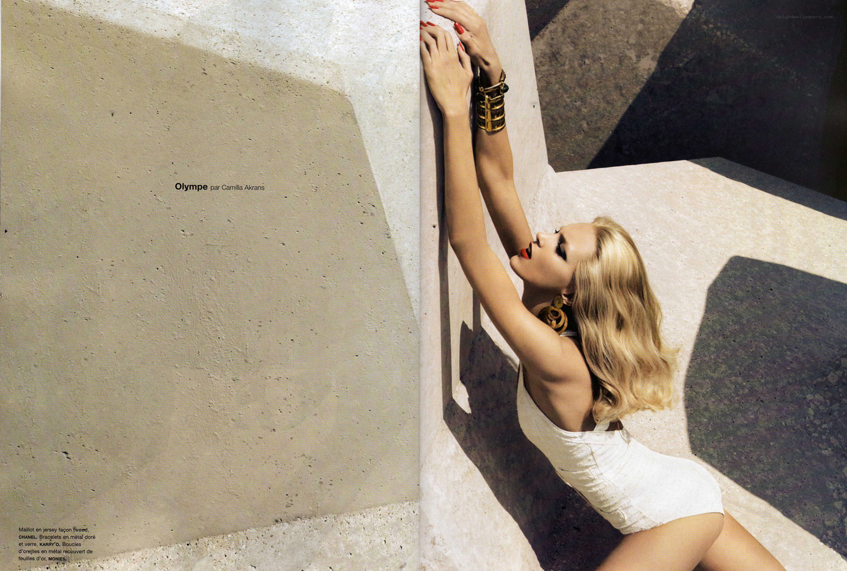 Model in white dress on wall