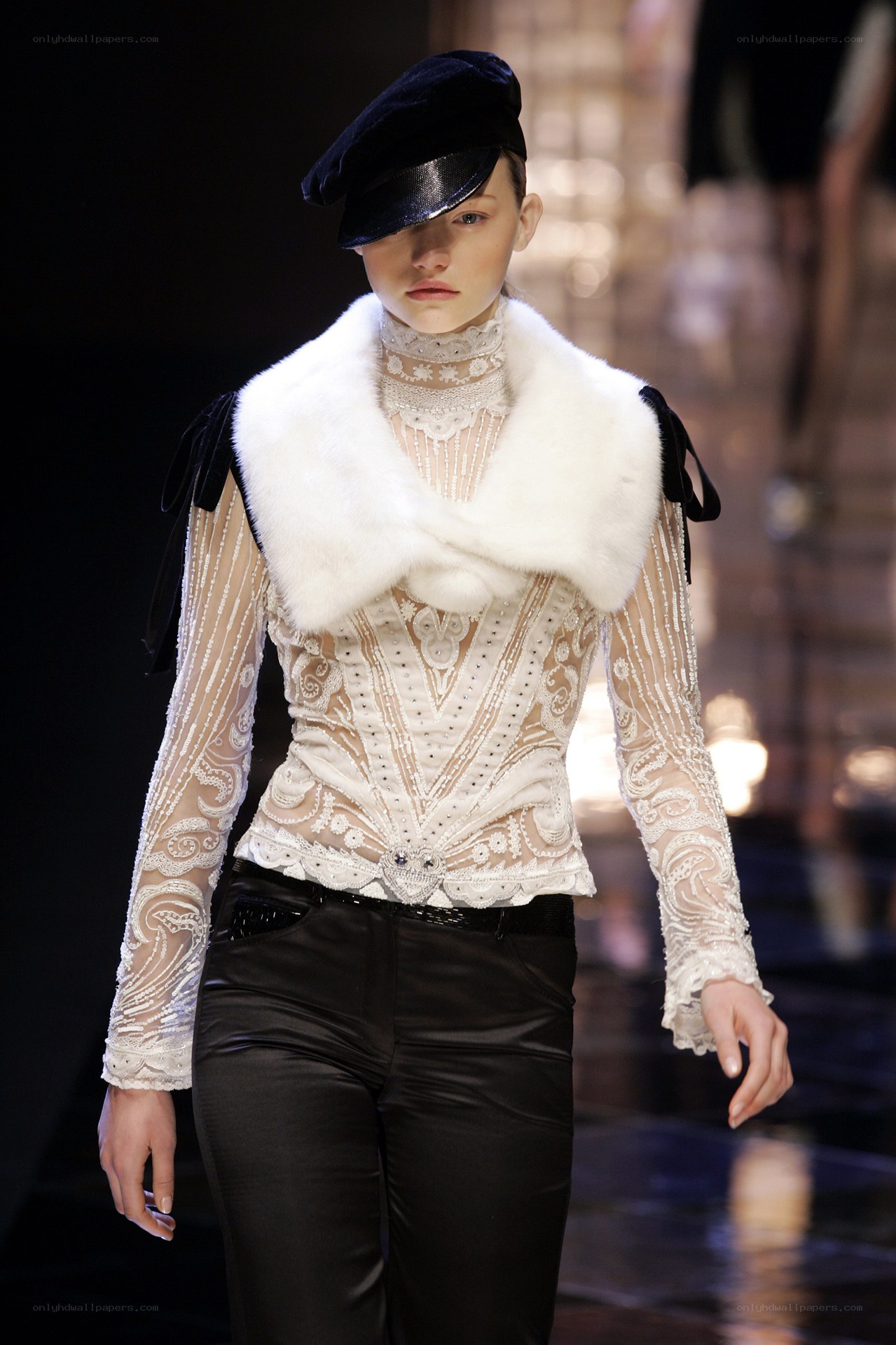 Model in white lace and black pants