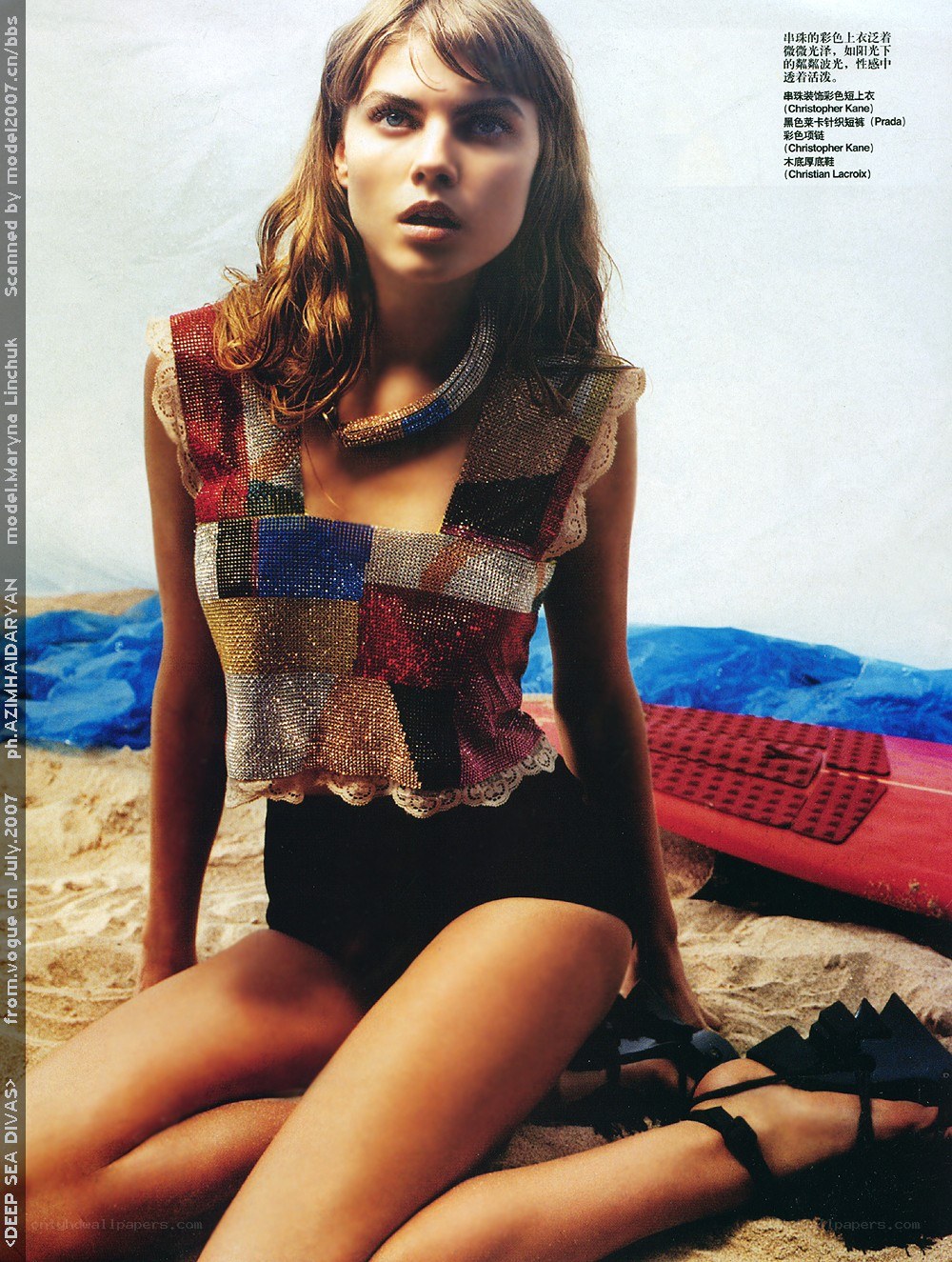 Model on beach in beaded top
