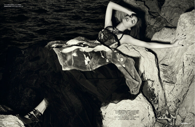 model on rocky shore