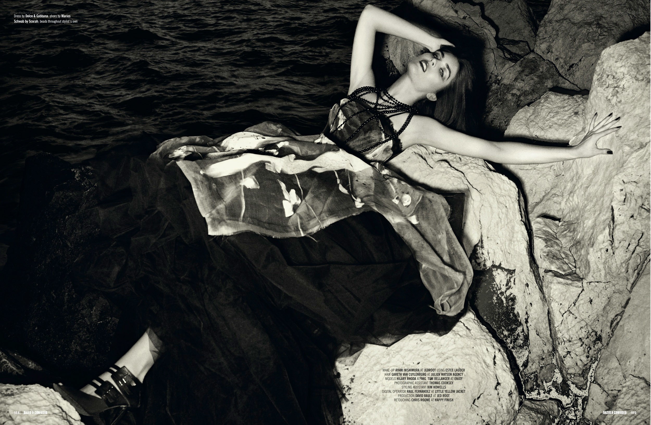 model on rocky shore