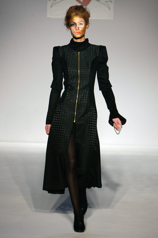 Model on runway in avant-garde coat