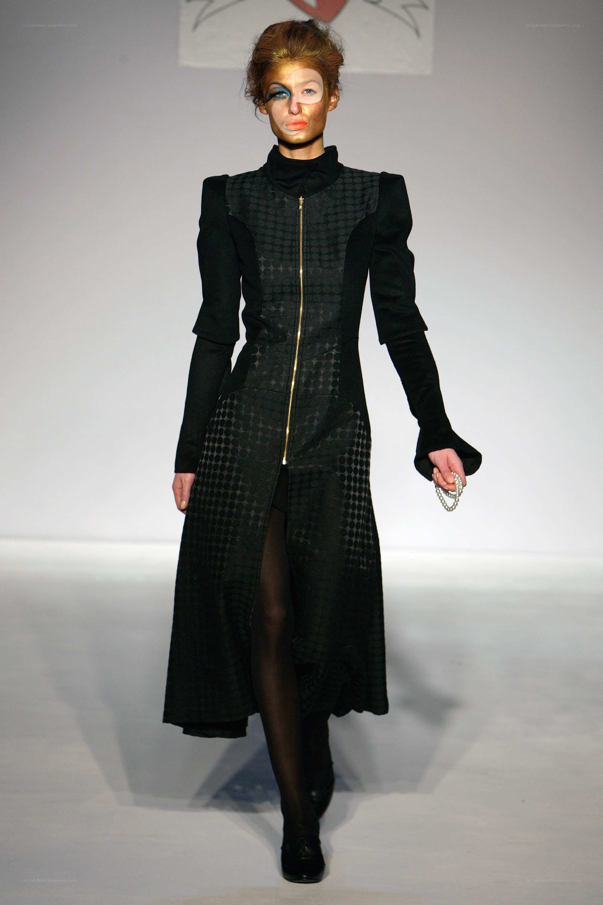Model on runway in avant-garde coat