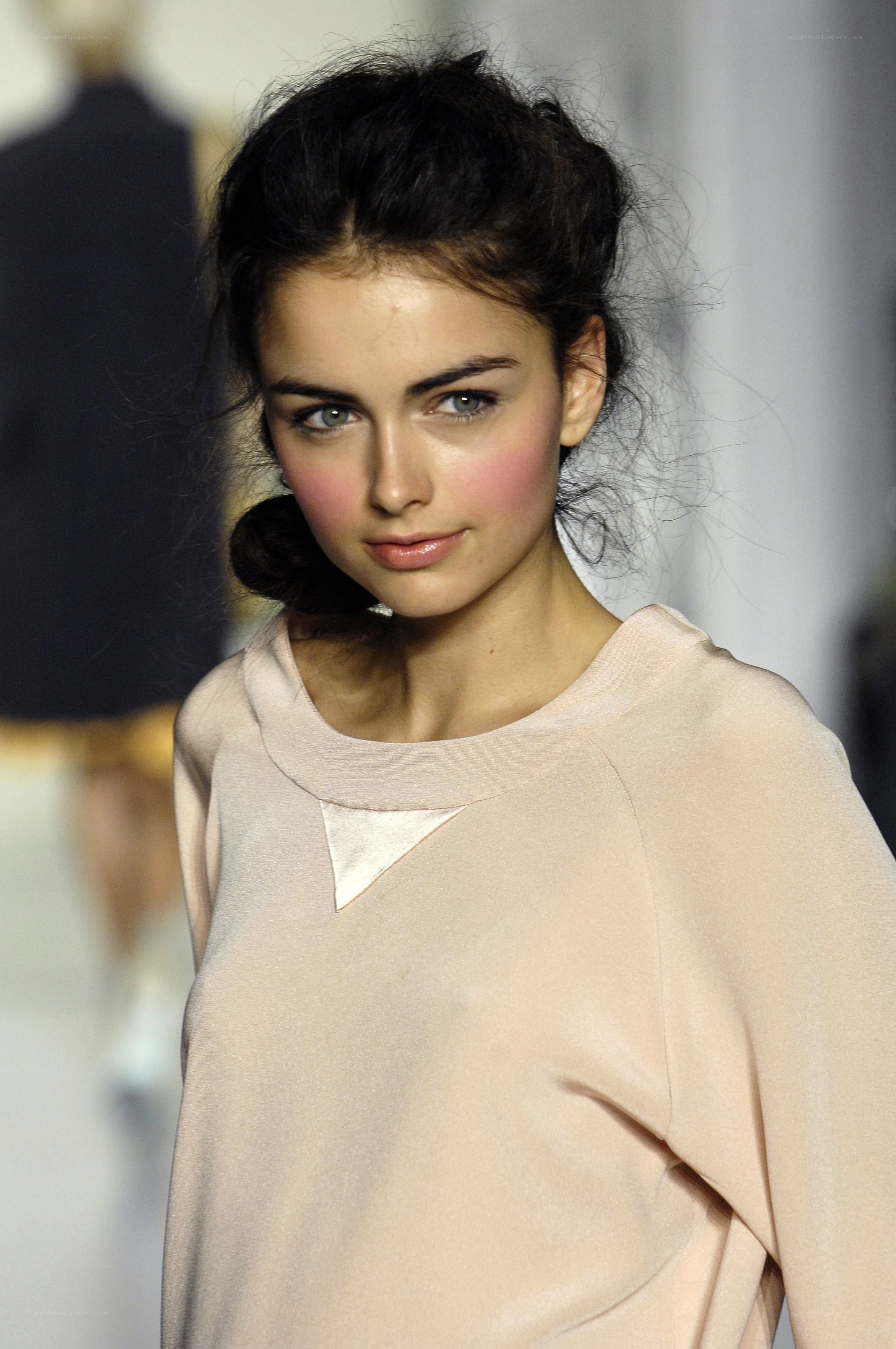 model on runway in beige top