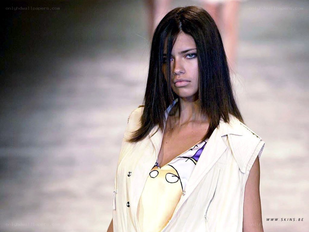 model on runway in beige vest
