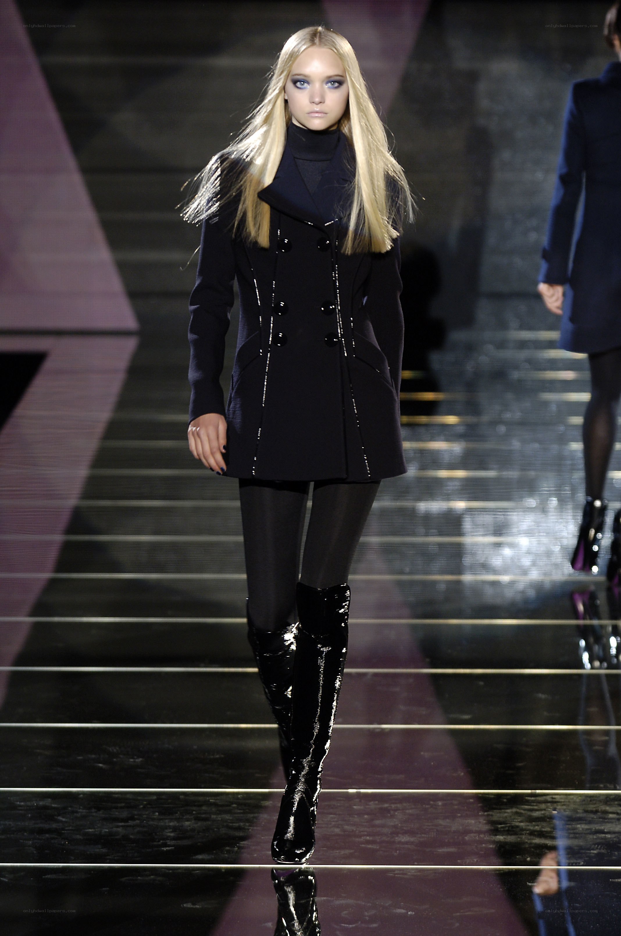 model on runway in black coat