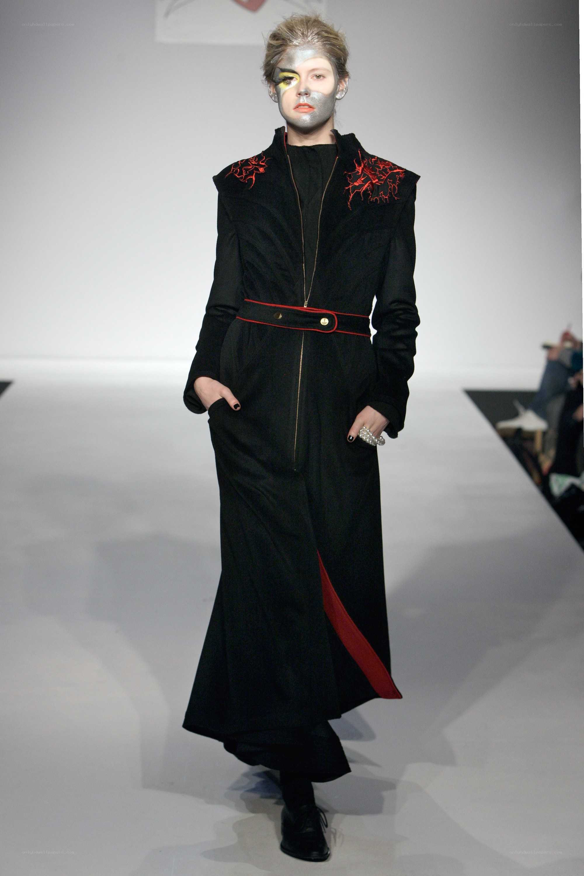 Model on runway in black coat