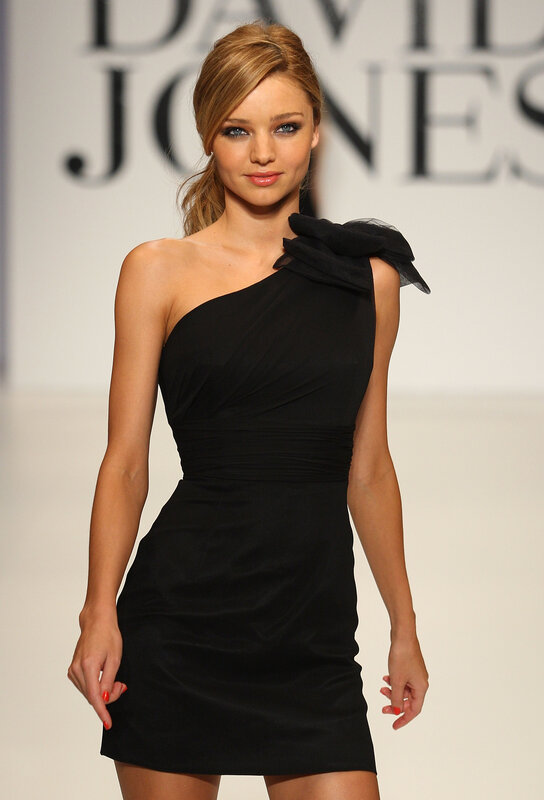 Model on runway in black dress