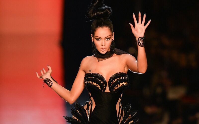 Model on runway in black dress