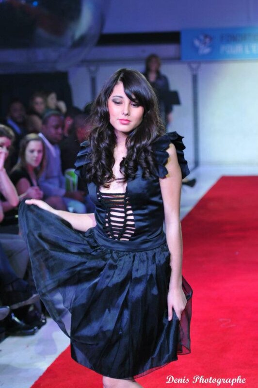 Model on runway in black dress