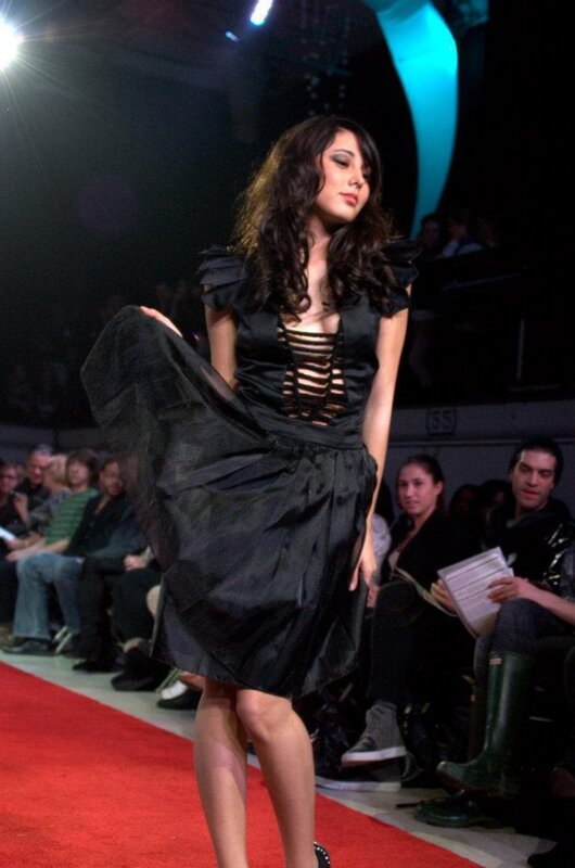 Model on runway in black dress