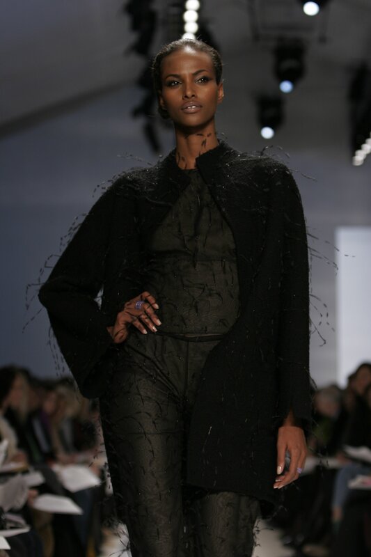 Model on runway in black ensemble