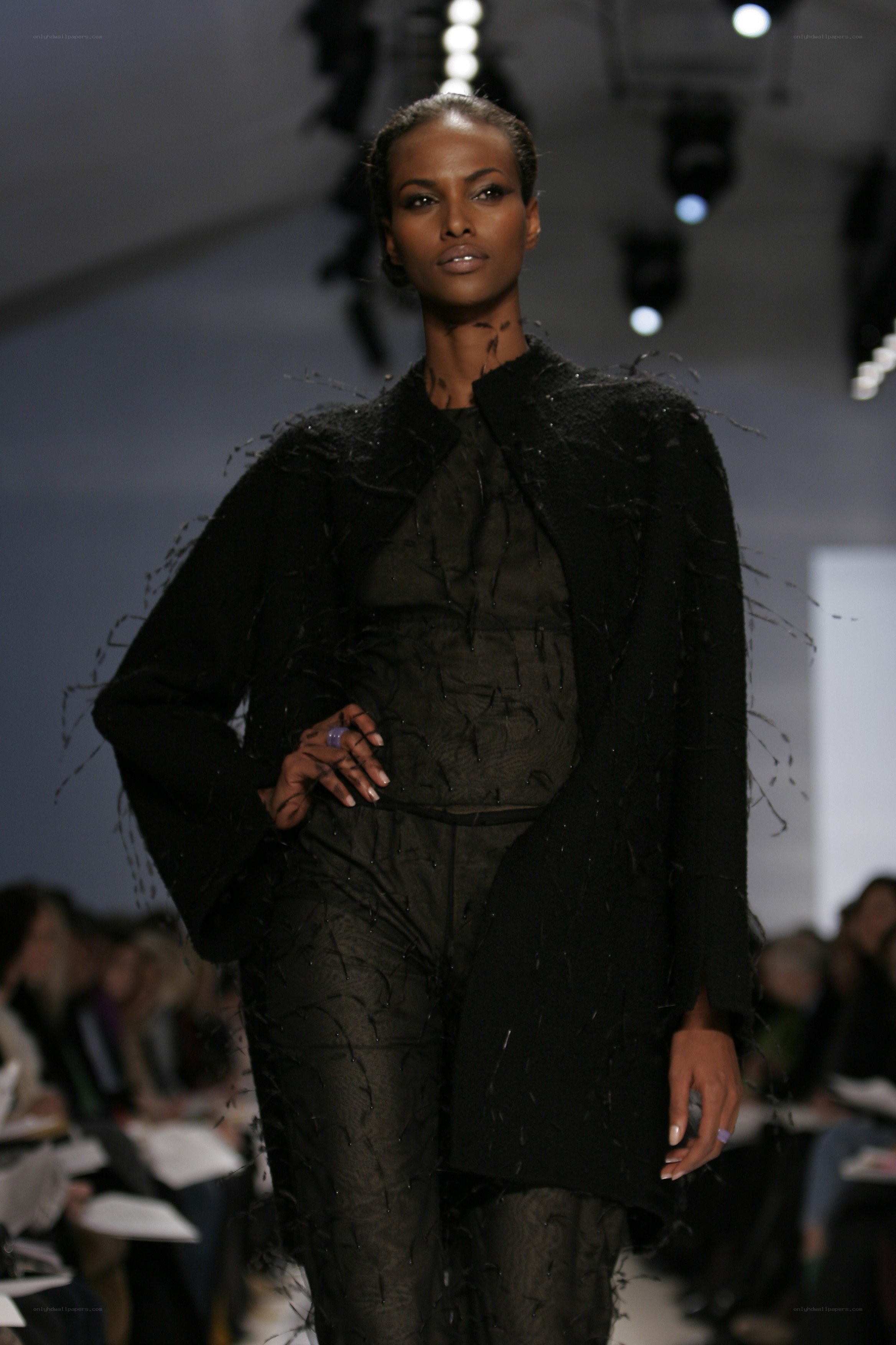 Model on runway in black ensemble