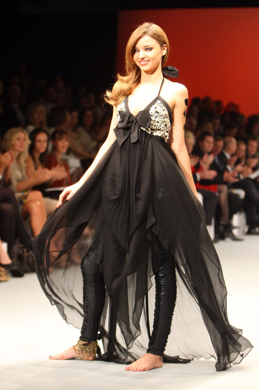 Model on runway in black gown