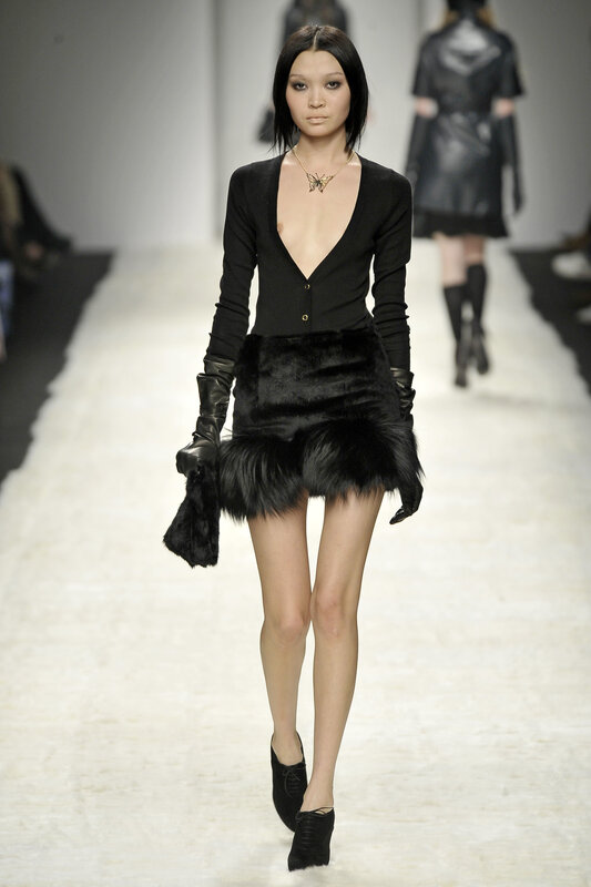 Model on runway in black outfit