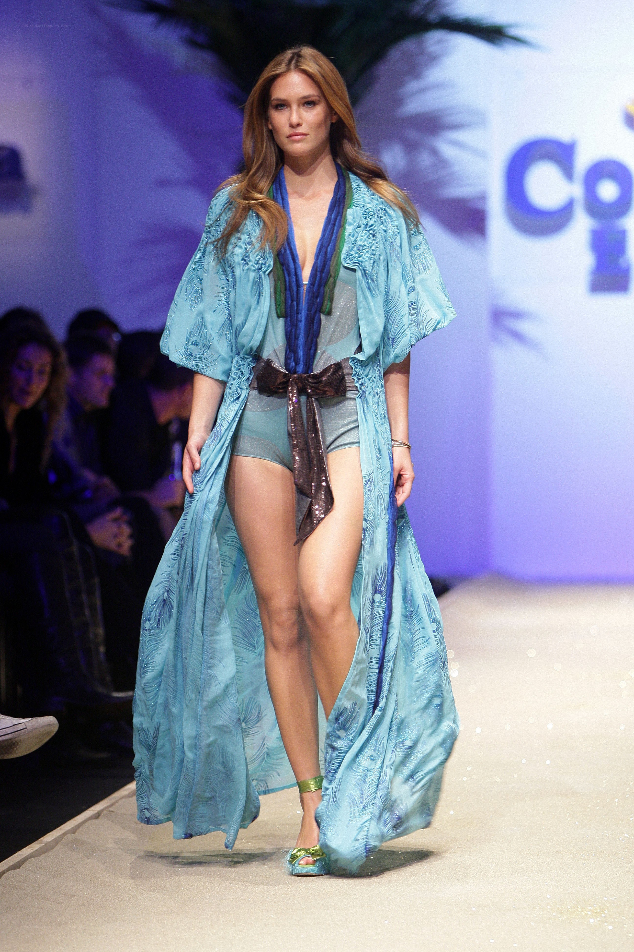 Model on runway in blue outfit