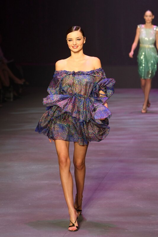 Model on runway in colorful dress