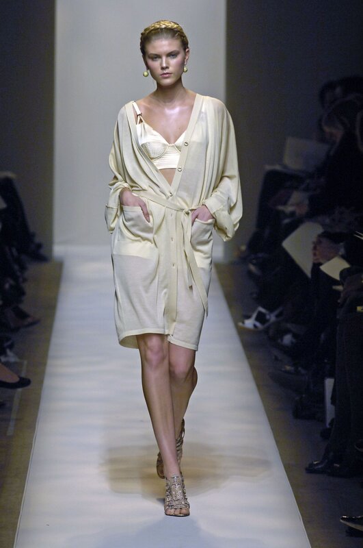 Model on runway in cream outfit