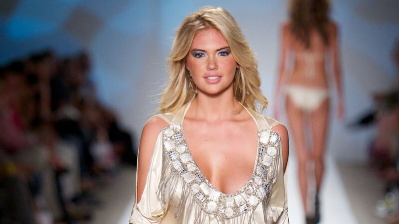model on runway in embellished dress