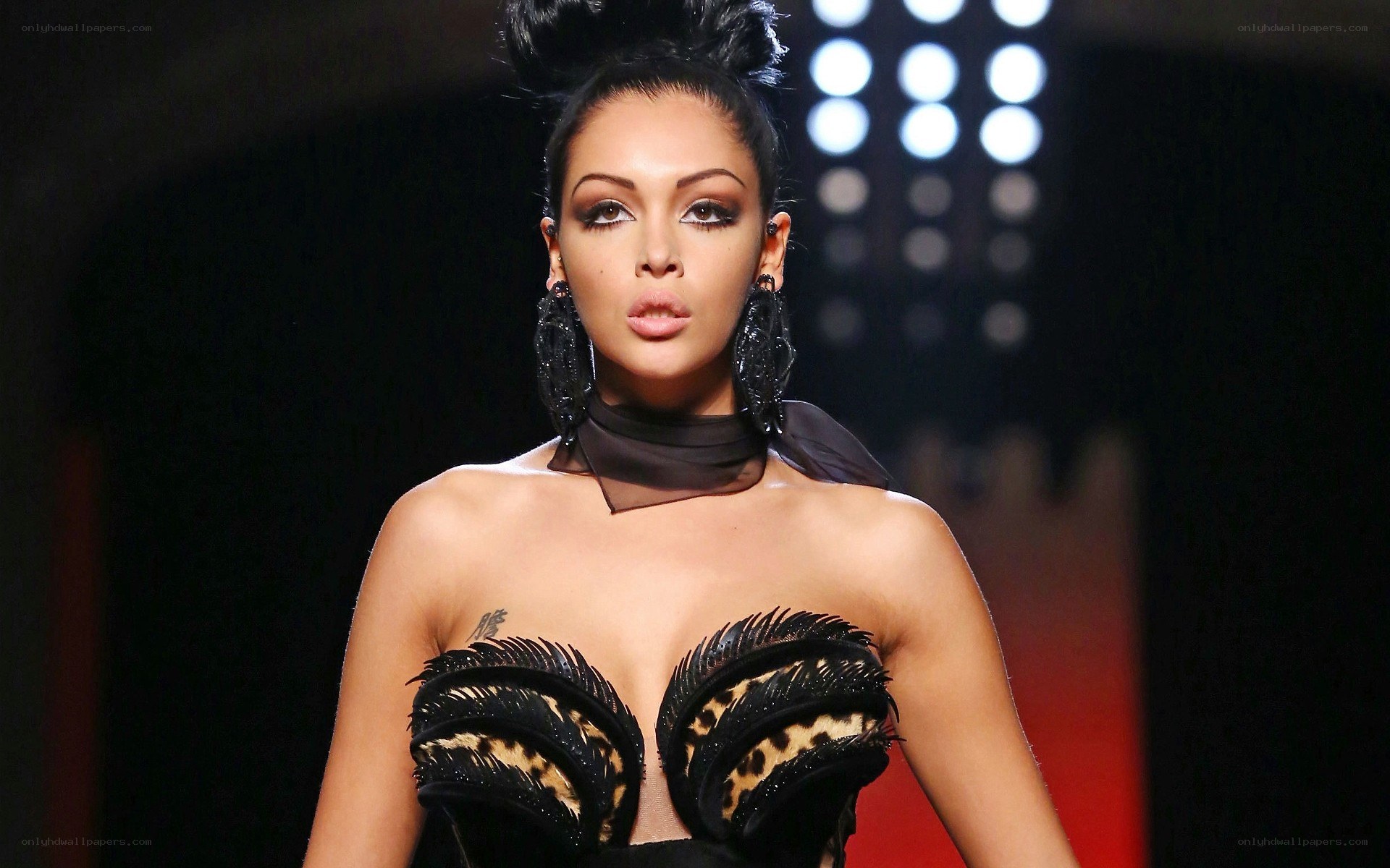 model on runway in feathered top