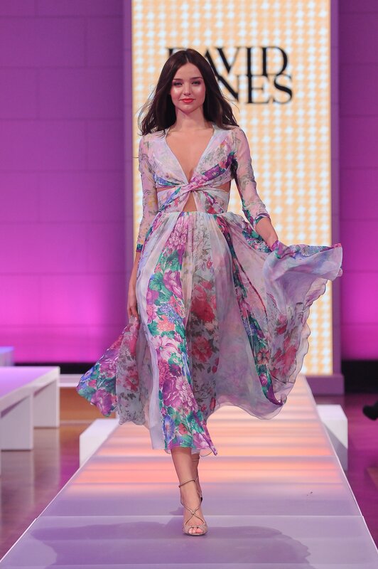 Model on runway in floral dress