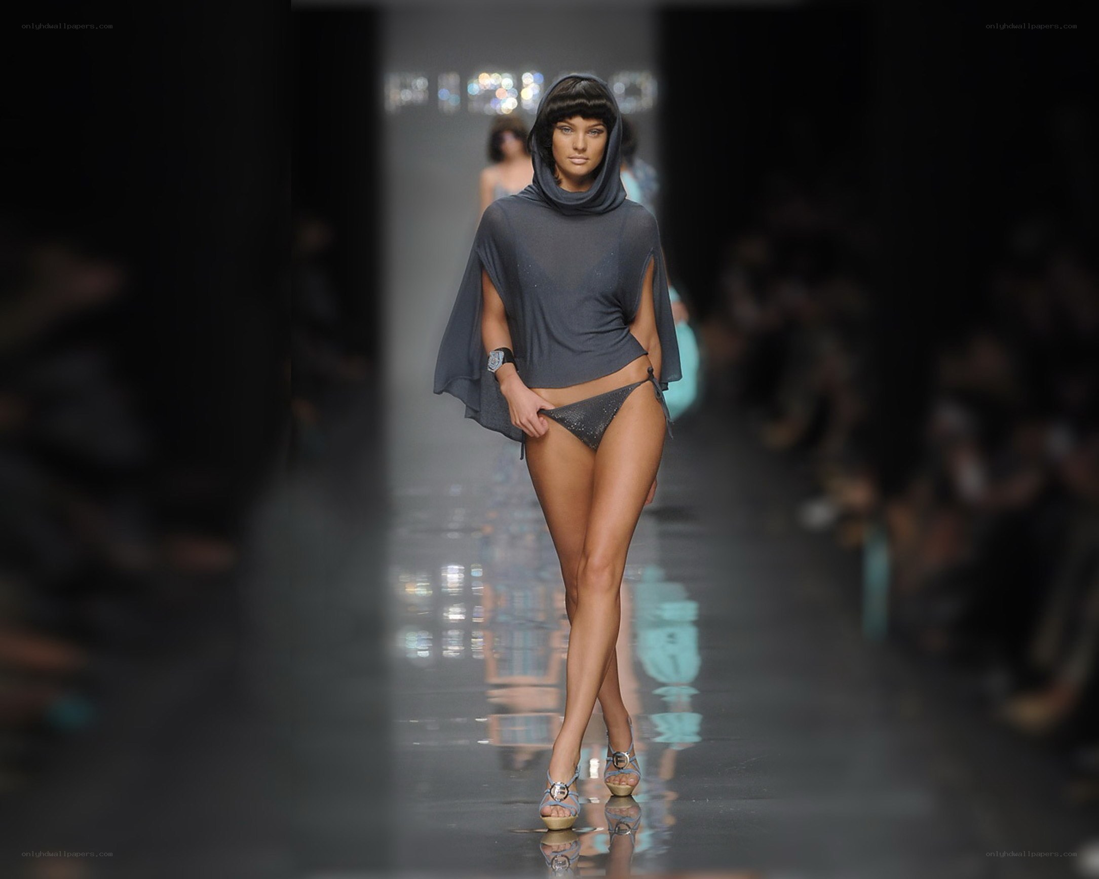 Model on runway in hooded top