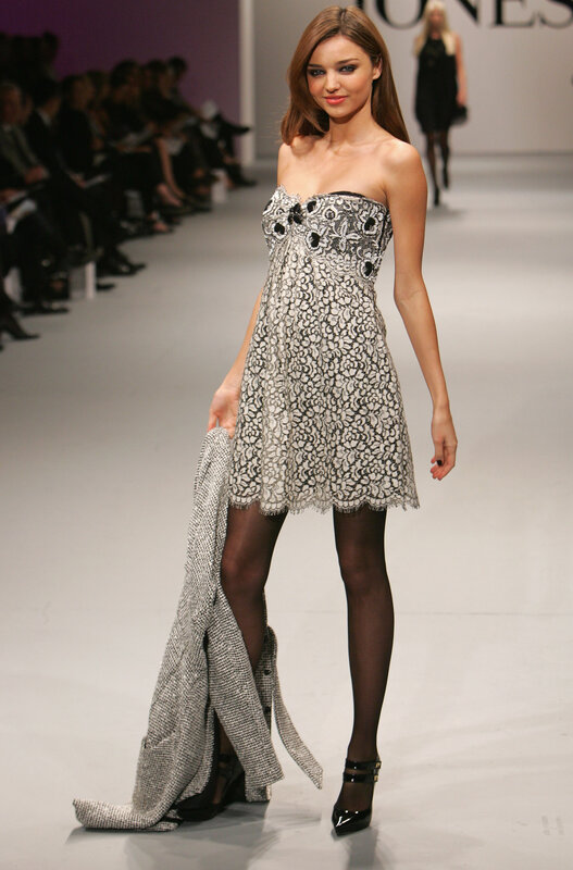Model on runway in lace dress