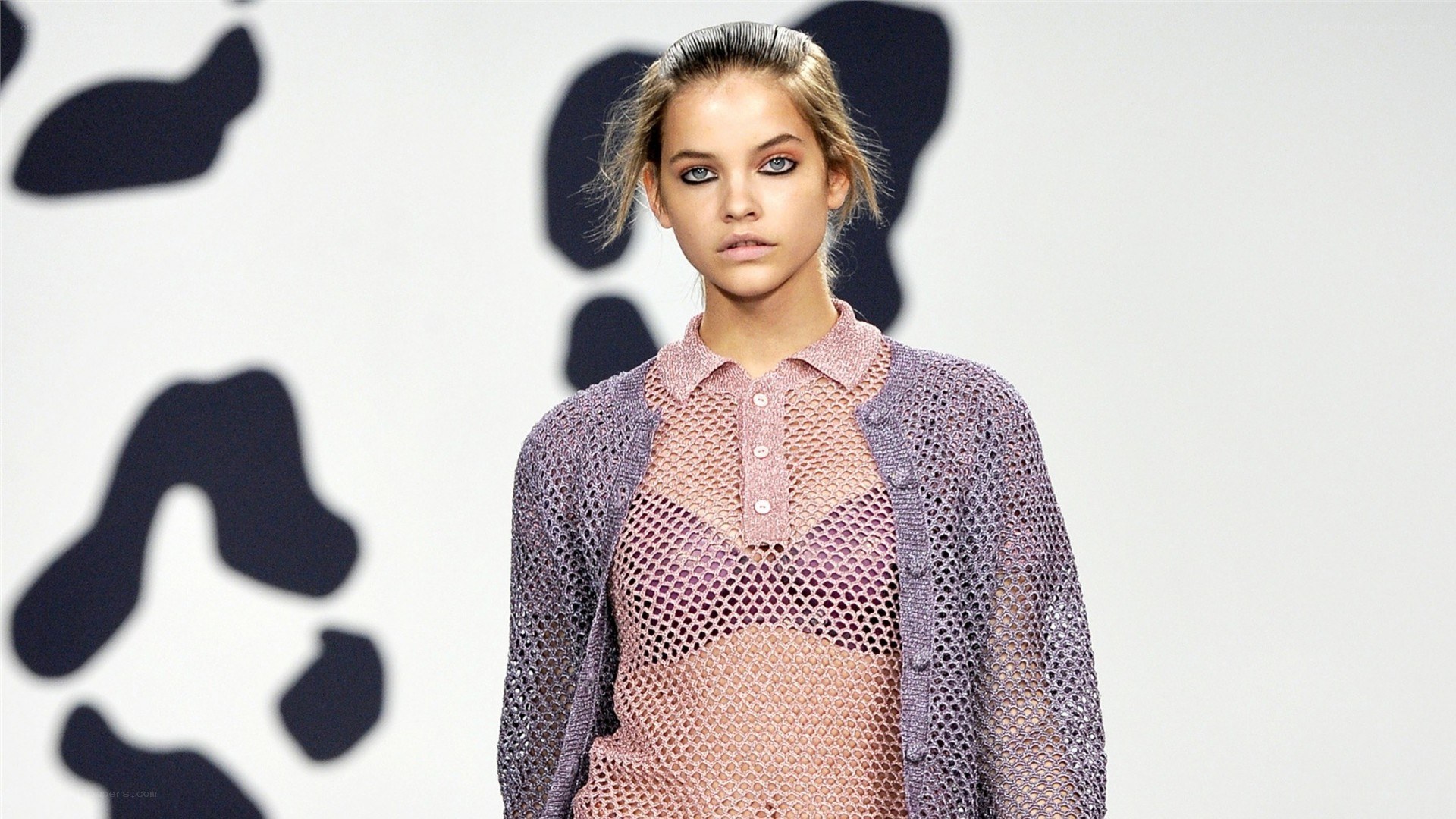Model on runway in mesh outfit