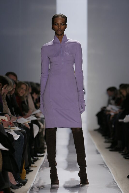 Model on runway in purple dress