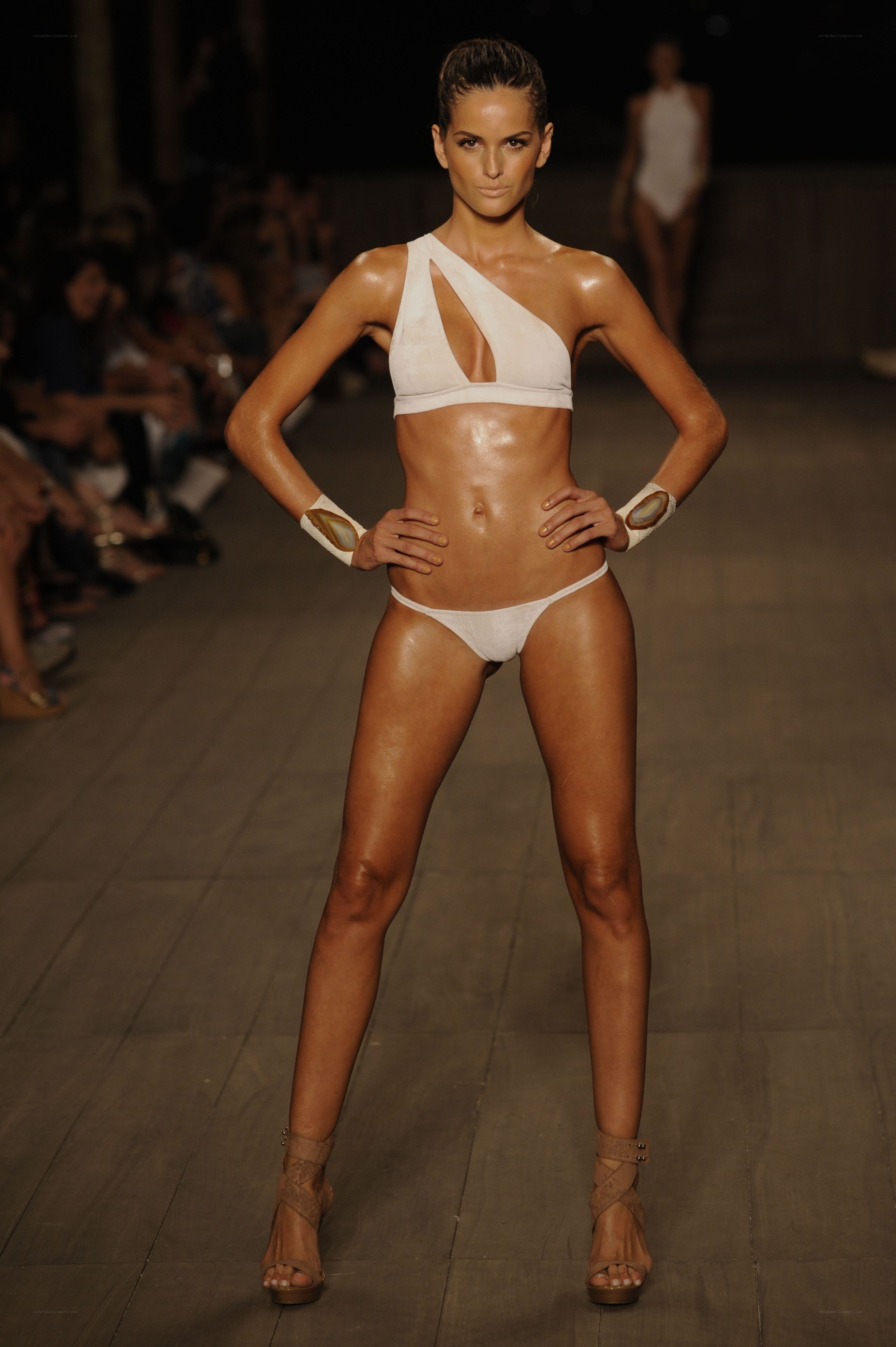 Model on runway in white bikini