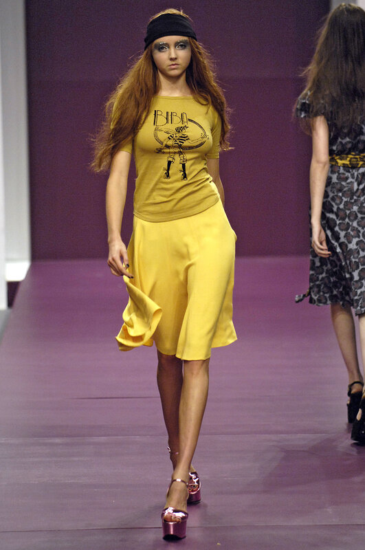 Model on runway in yellow outfit