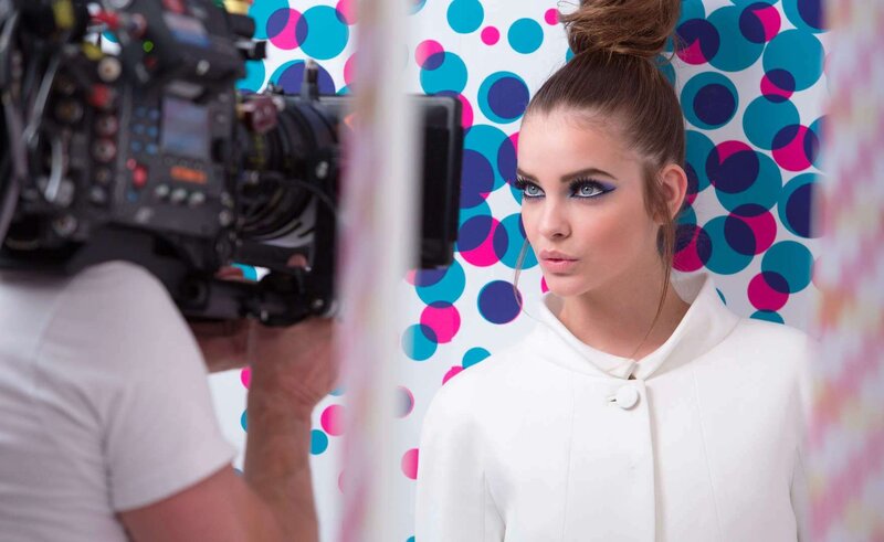 model on set with camera