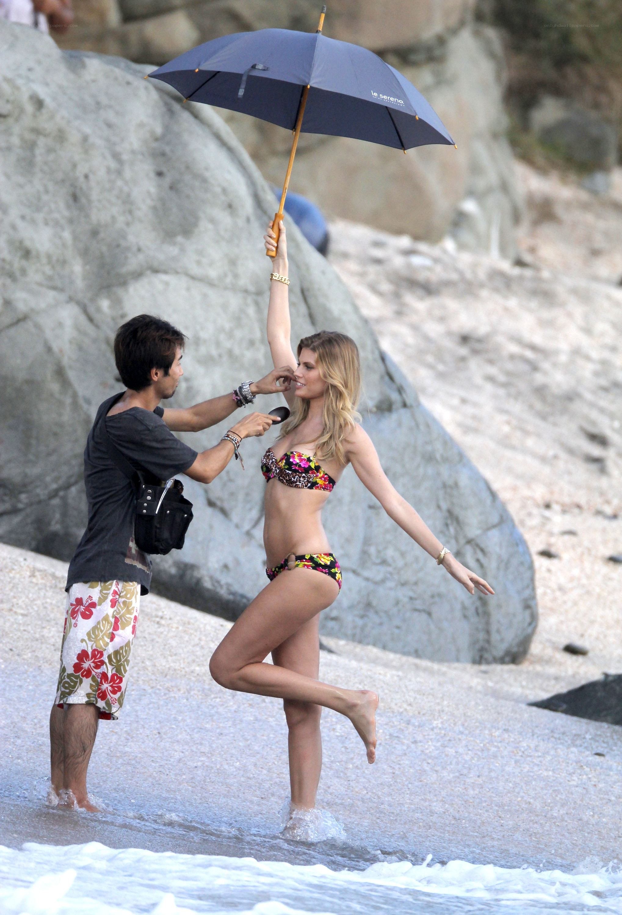 model posing on beach with umbrella