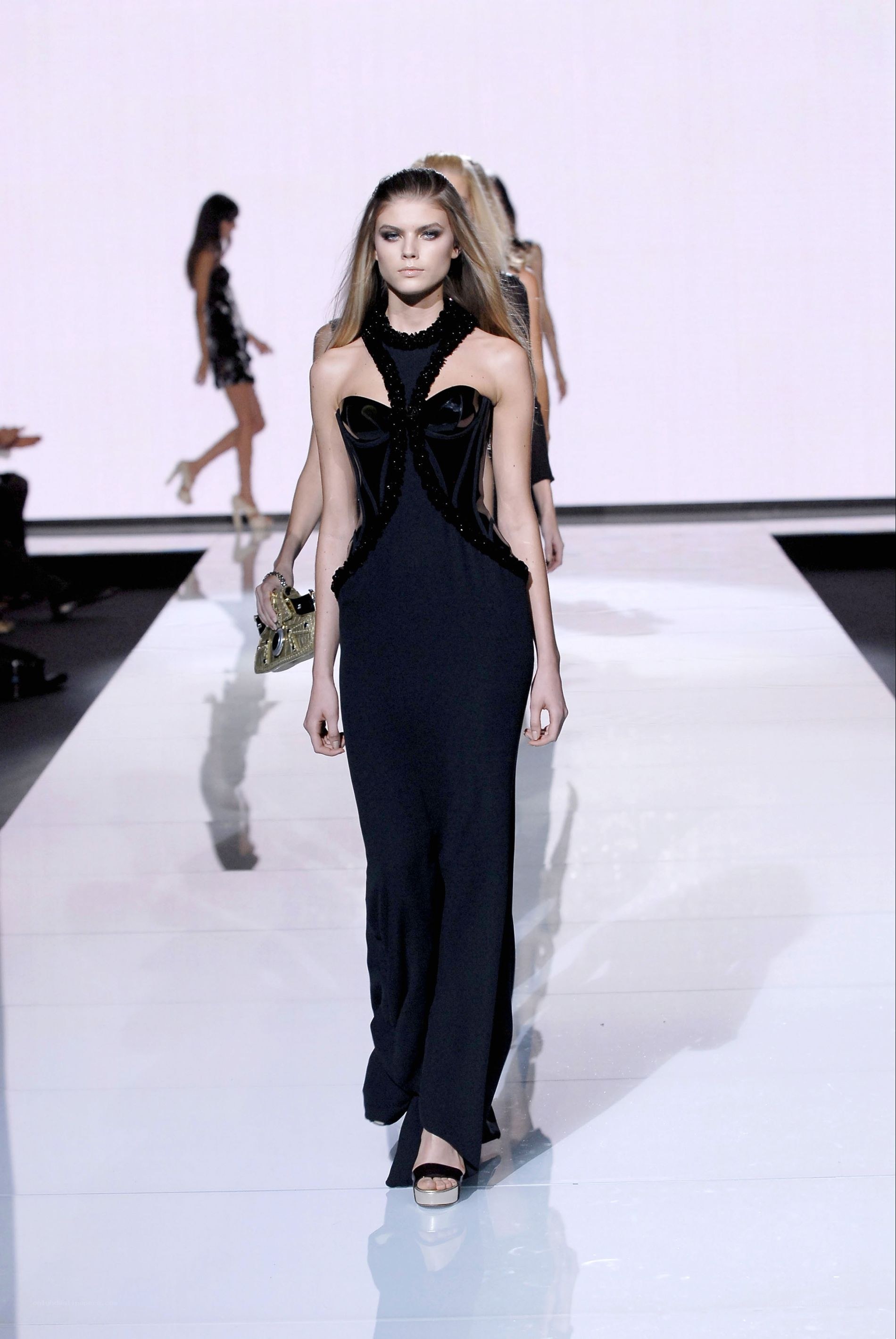 Model walks runway in black gown