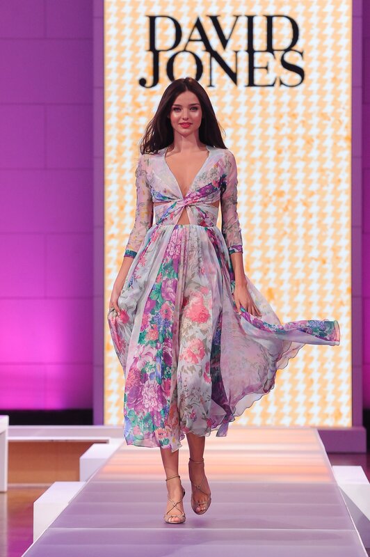 Model walks runway in floral dress