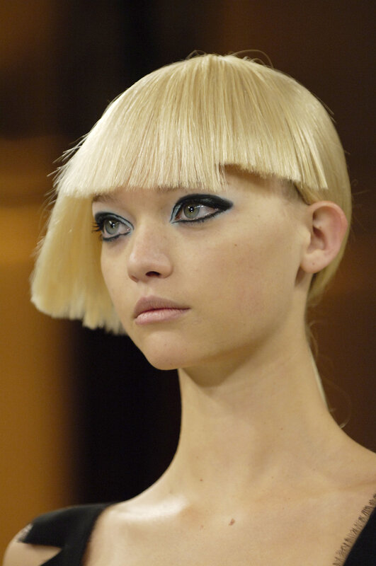 model with blonde bob and bold makeup