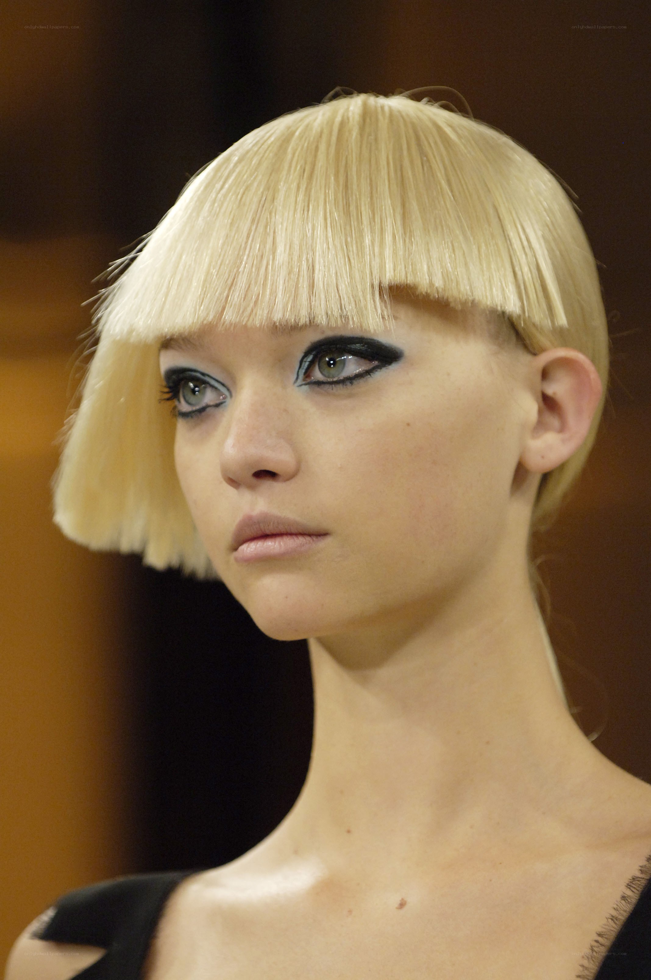 model with blonde bob and bold makeup