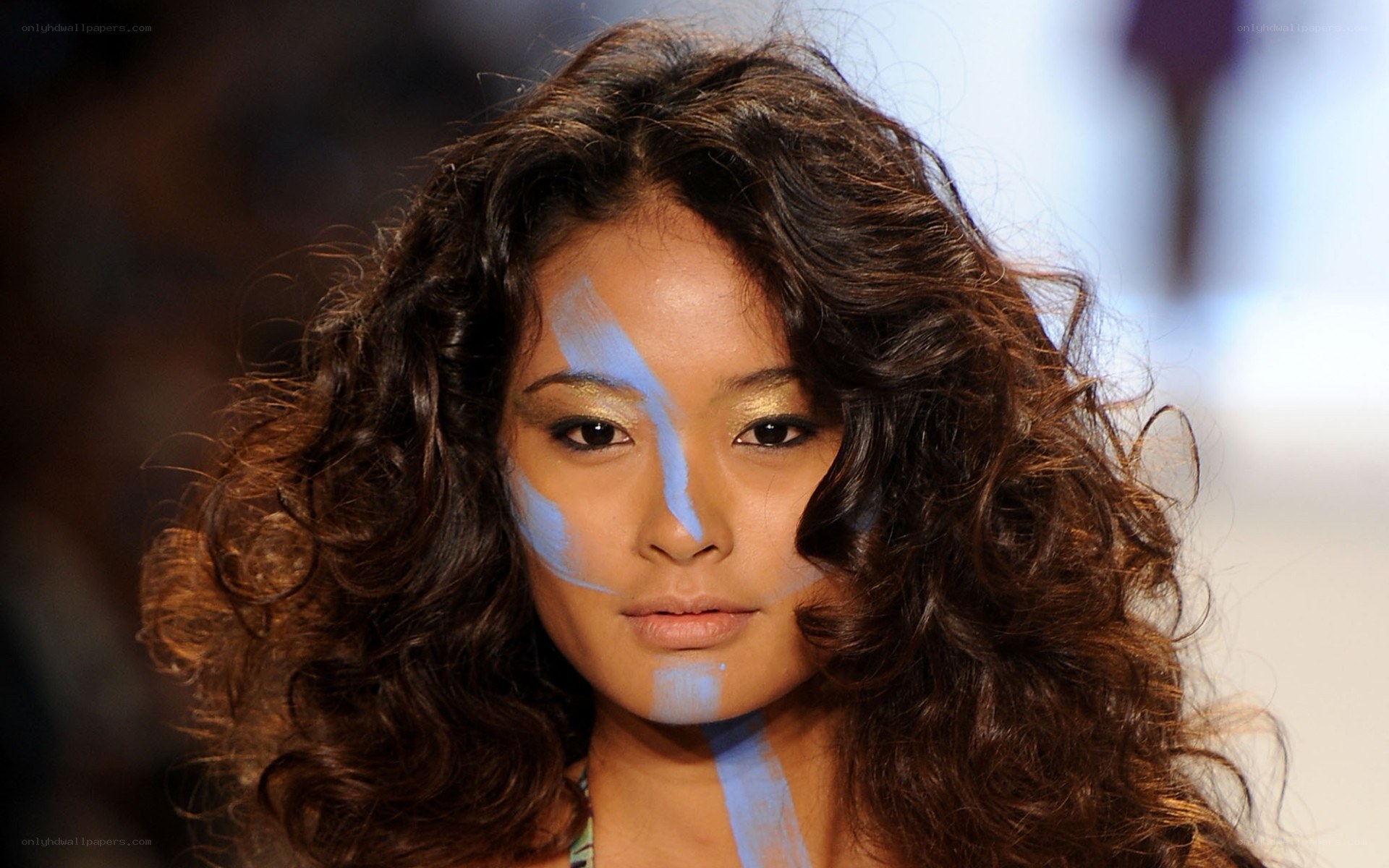 model with blue face paint