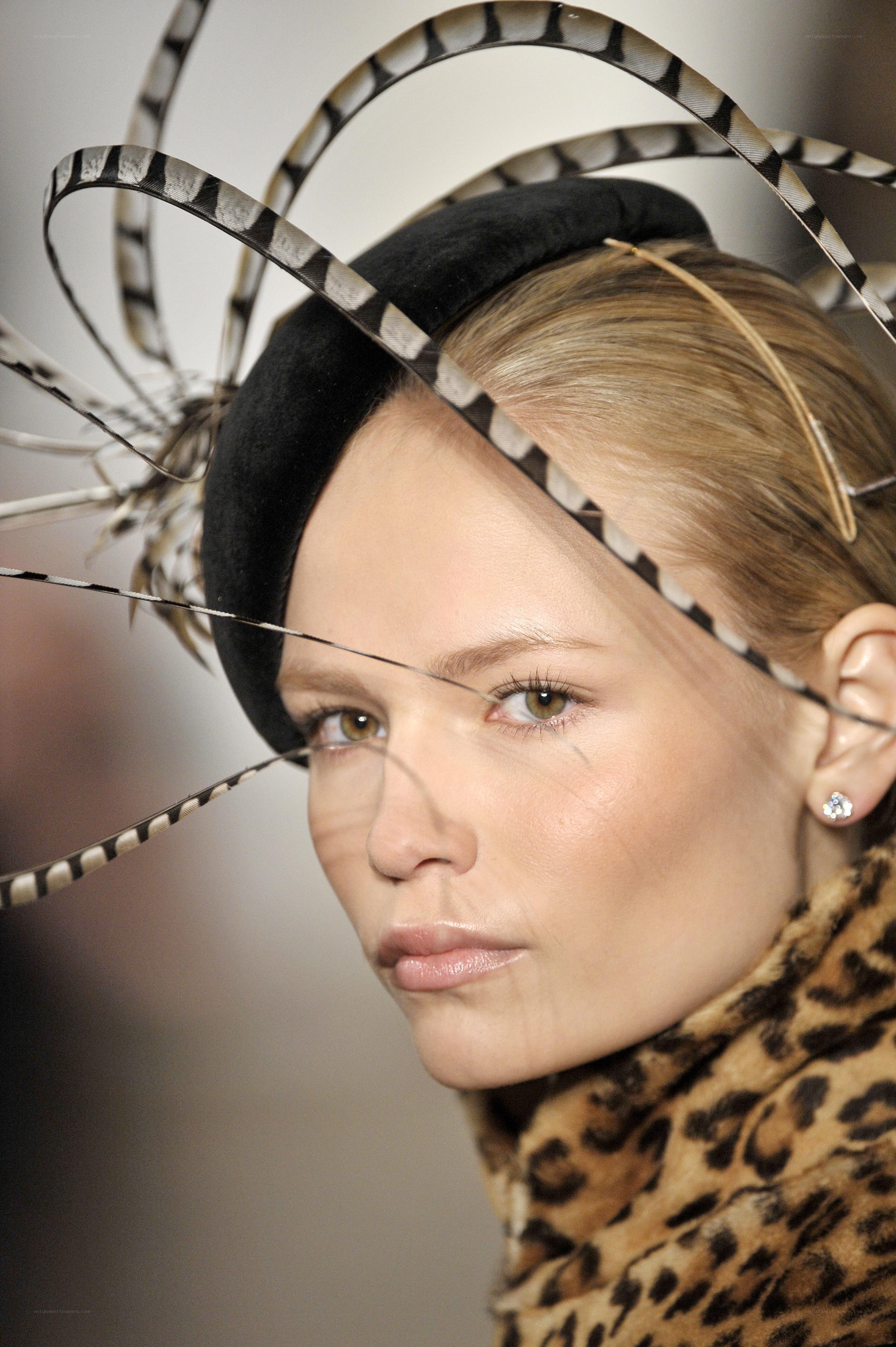 model with feather headpiece