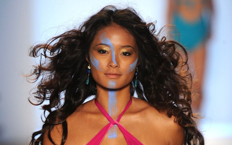 Model with painted face on runway