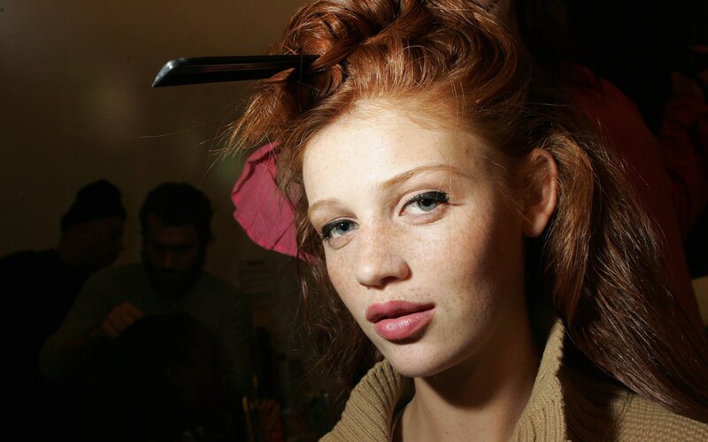 model with red hair and freckles