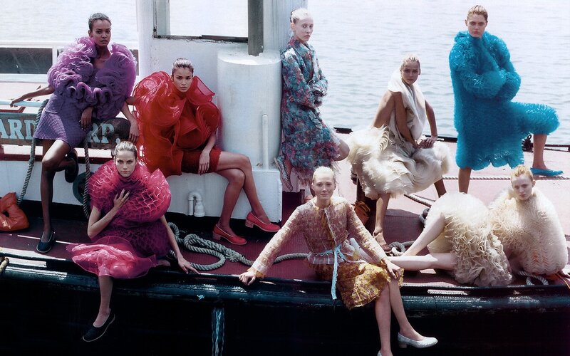 Models in avant-garde dresses on a boat