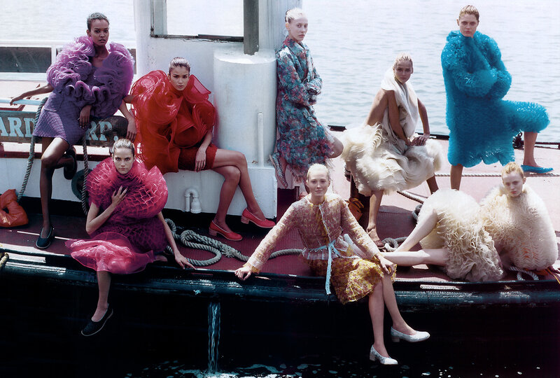 Models in avant-garde fashion on a boat