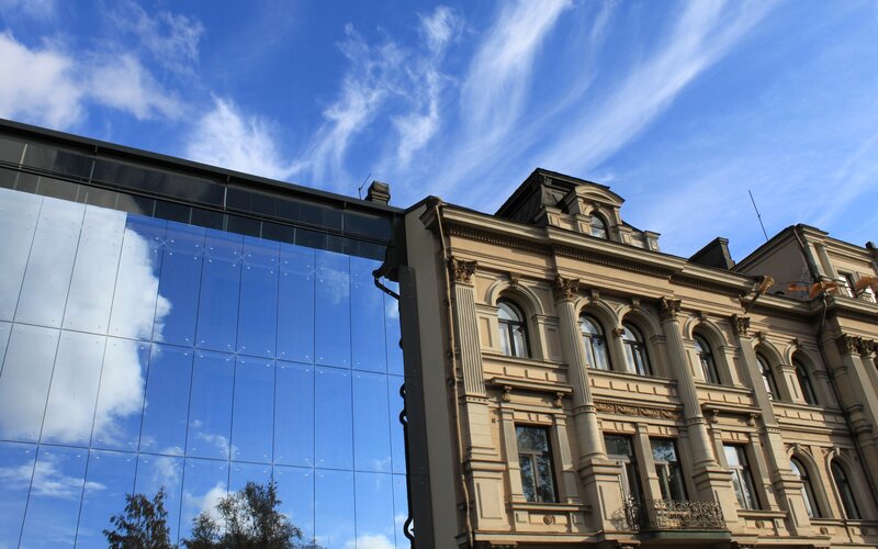 Modern and historic buildings under blue sky