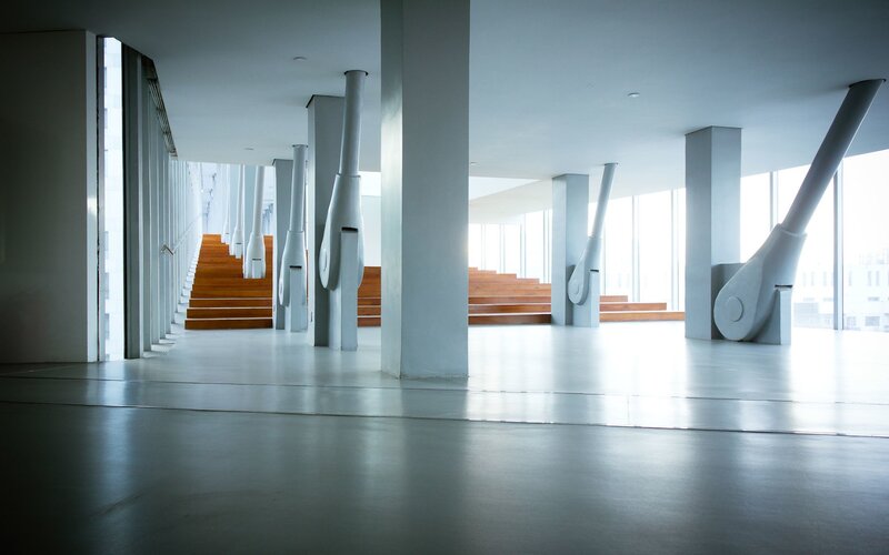 Modern architectural interior with wooden stairs
