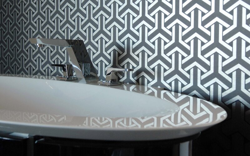 modern bathroom sink with geometric wallpaper