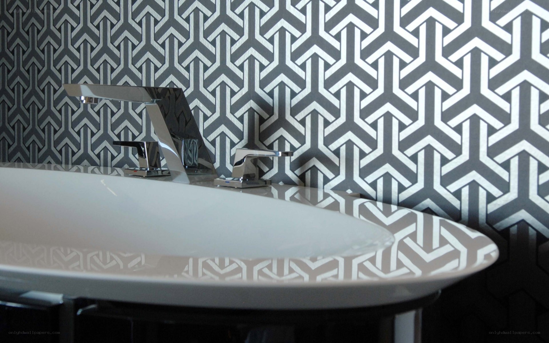 modern bathroom sink with geometric wallpaper