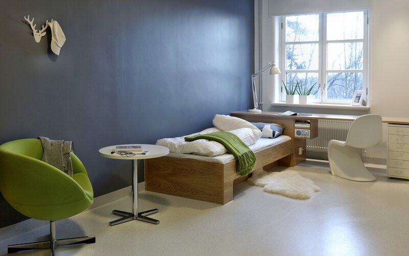 Modern bedroom with green chair